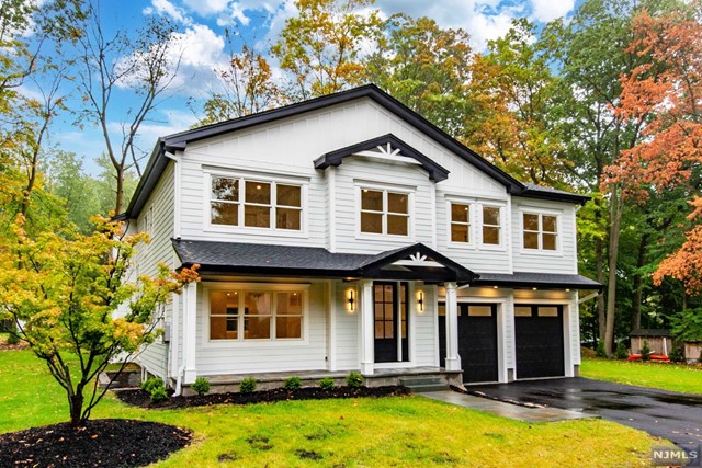 a front view of a house with yard porch and furniture