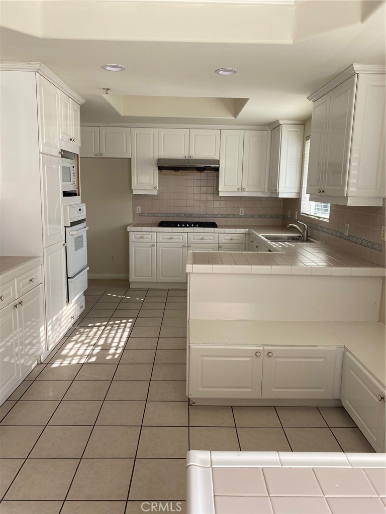 a kitchen with a cabinets and appliances