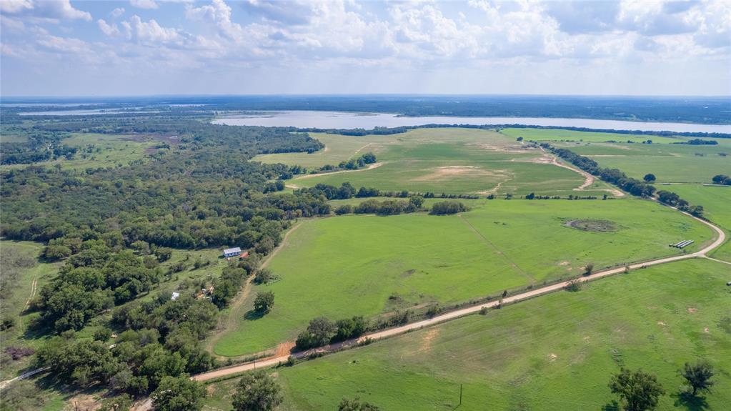 a view of a field with an ocean