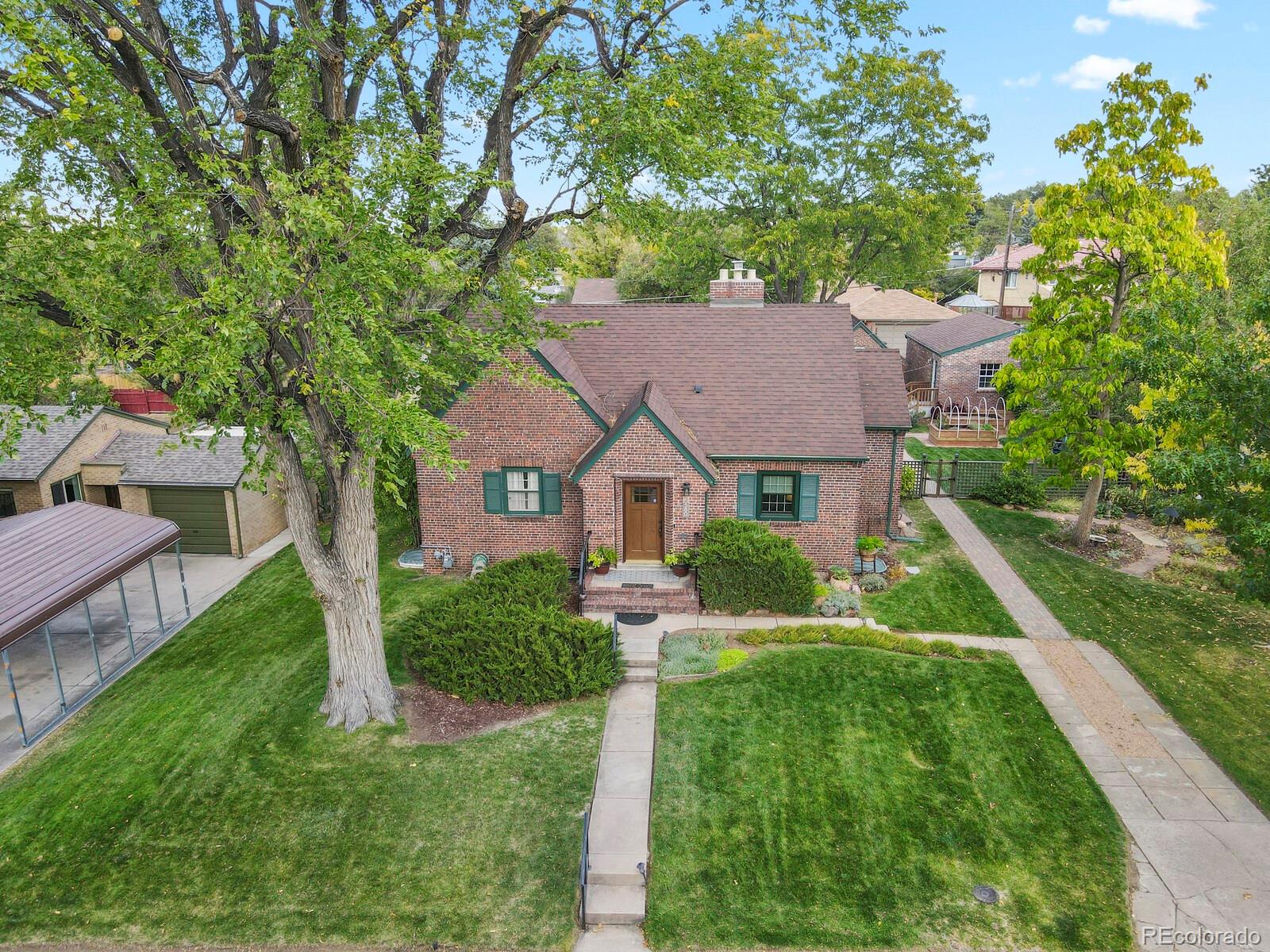 a front view of house with yard and green space