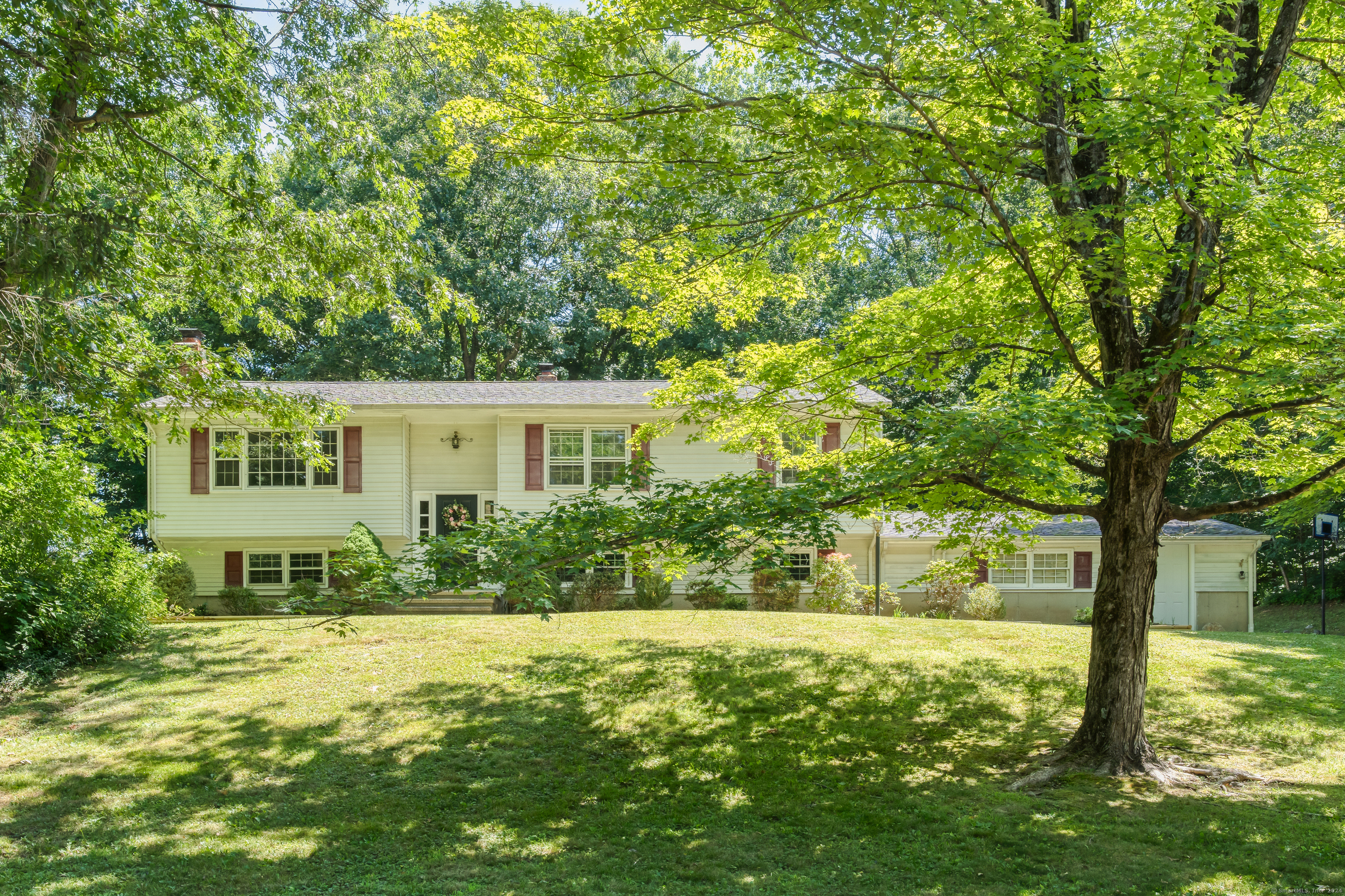 a view of backyard of house with green space