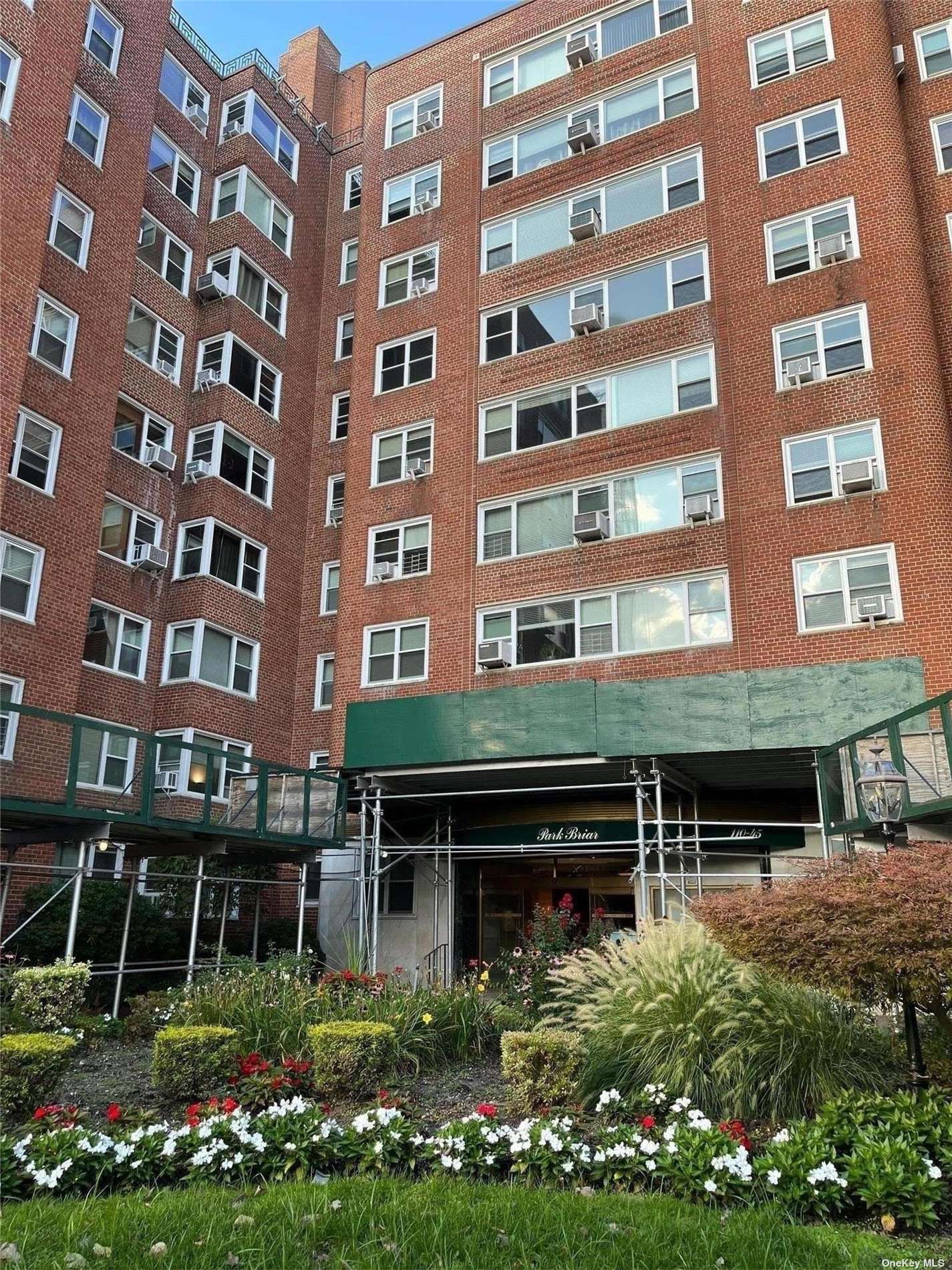 a view of a building with a lot of flower garden