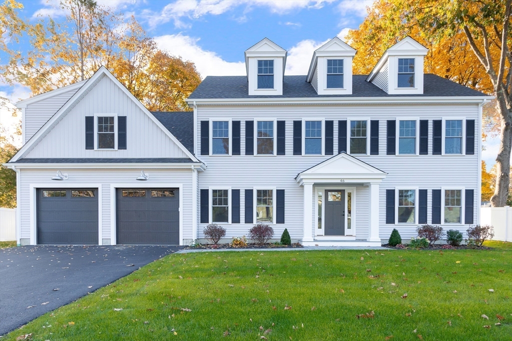 a front view of a house with a yard