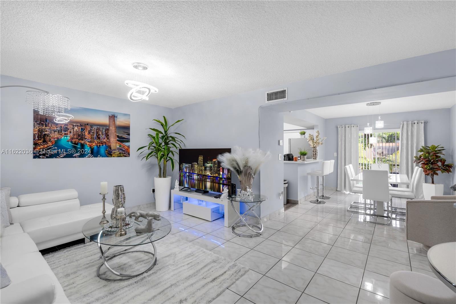 a living room with furniture a rug and white walls