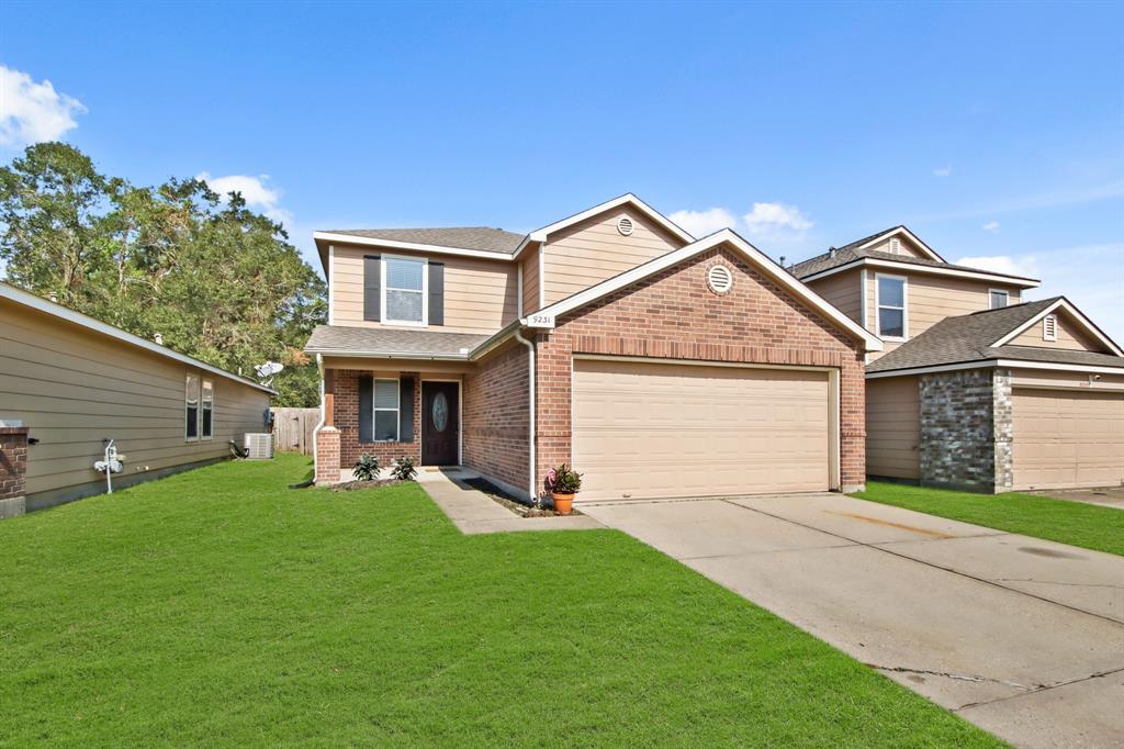 a front view of a house with a yard and garage