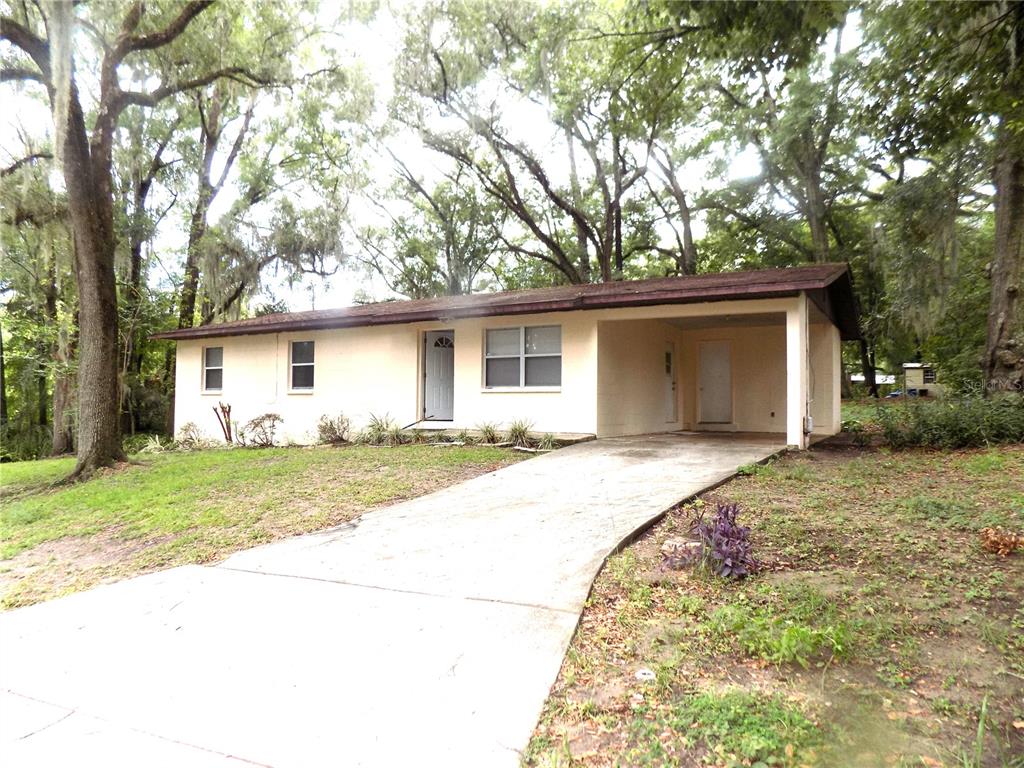 a view of a house with a yard and garage