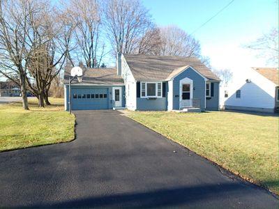 3 BR Cape home with a garage and a Huge yard on a corner double lot