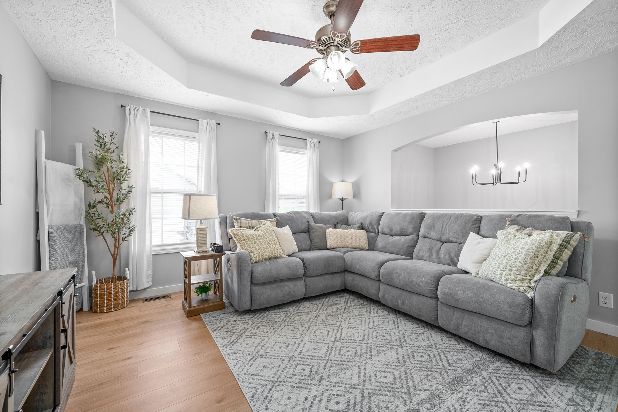 a living room with furniture and a chandelier