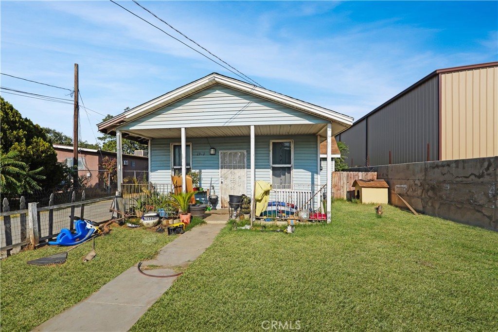 a view of a house with backyard porch and sitting area