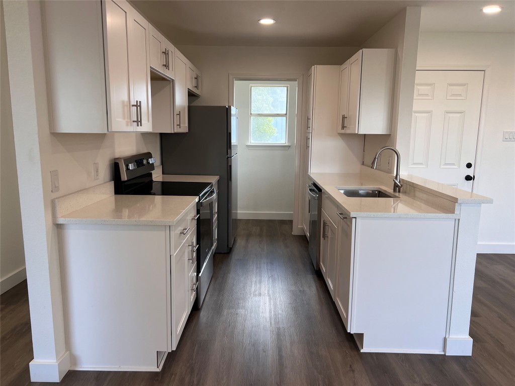 a kitchen with stainless steel appliances a stove top oven