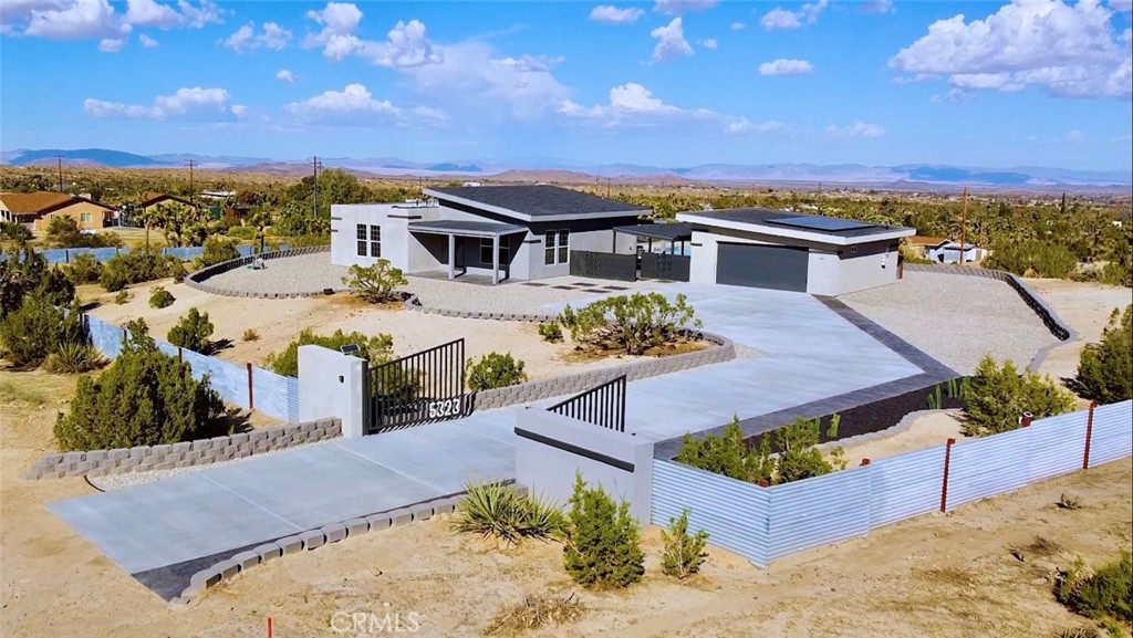 an aerial view of a house with a swimming pool