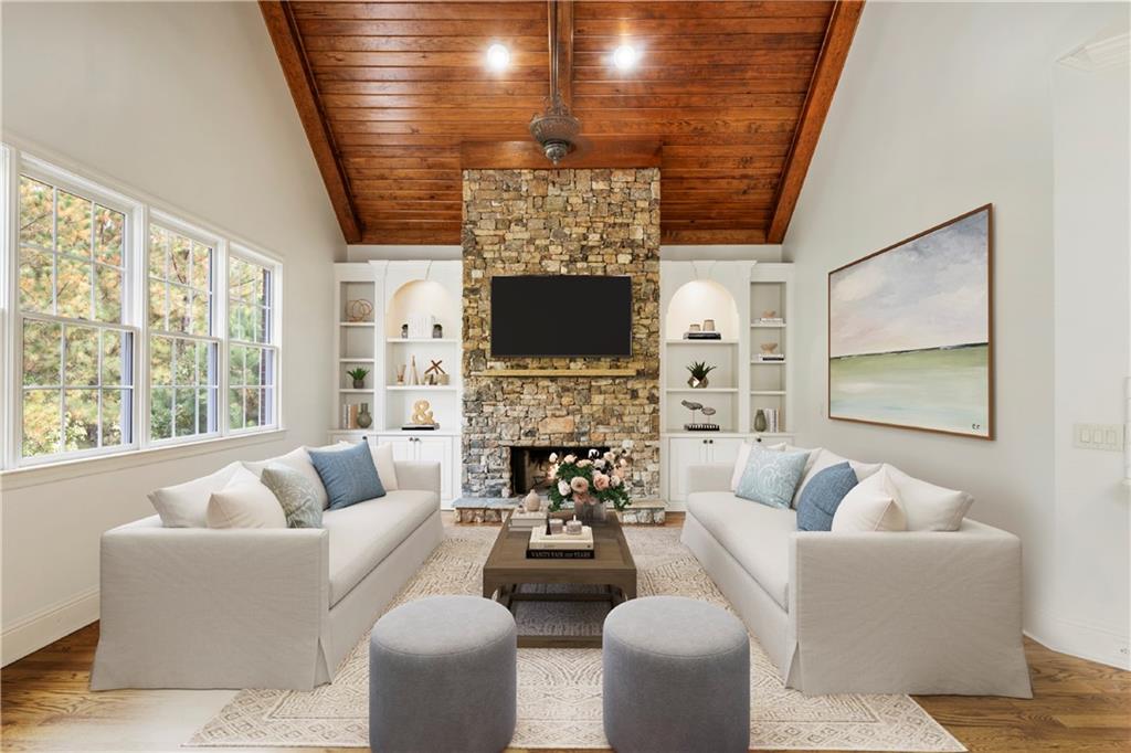 a living room with fireplace furniture and a large window