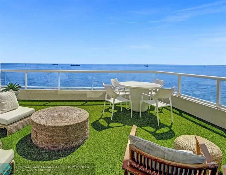 a view of an outdoor sitting area with furniture and swimming pool