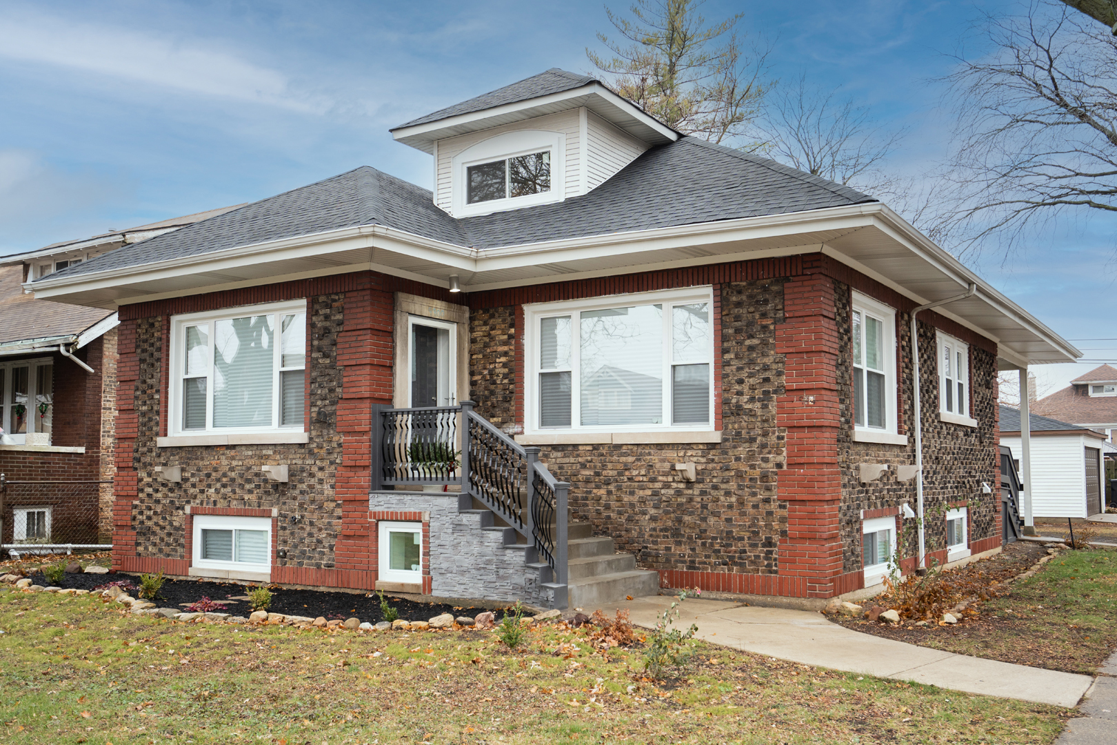 a front view of a house with garden