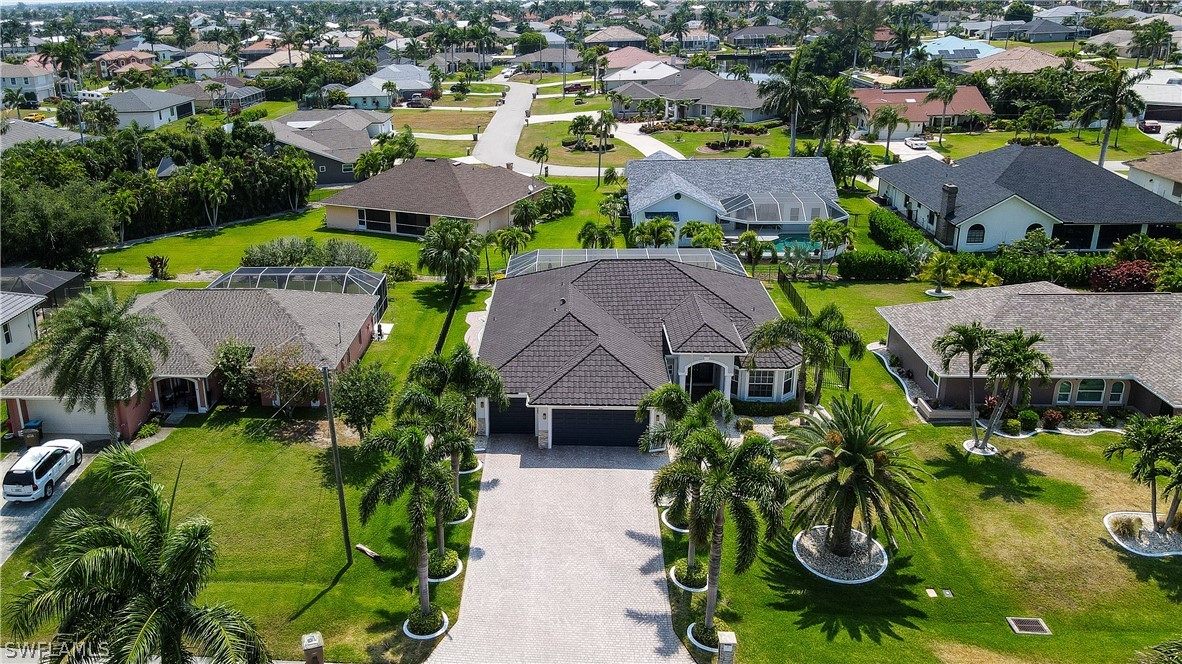 an aerial view of multiple houses with yard