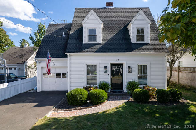 a view of a house with a yard and garage