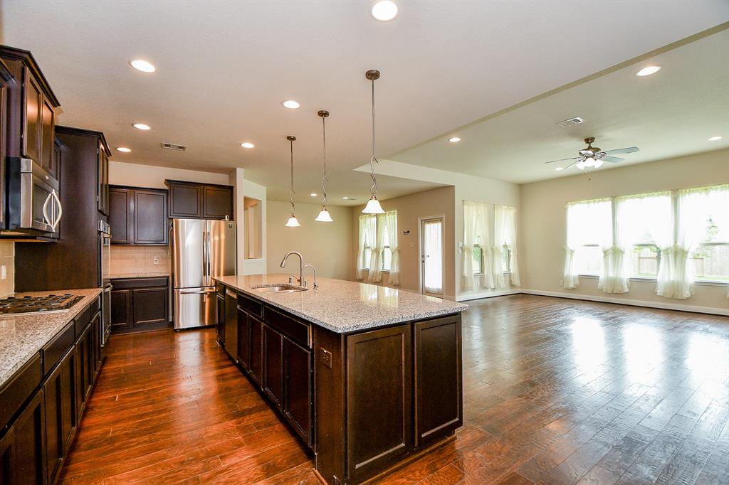 a kitchen with counter top space a sink appliances and cabinets