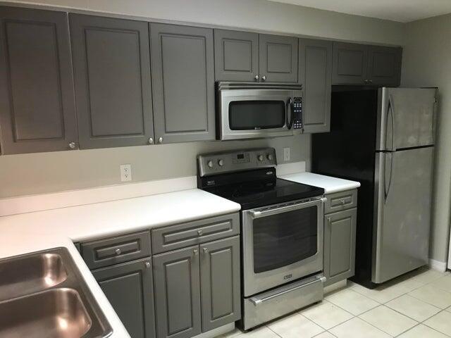 a kitchen with a stove microwave and refrigerator