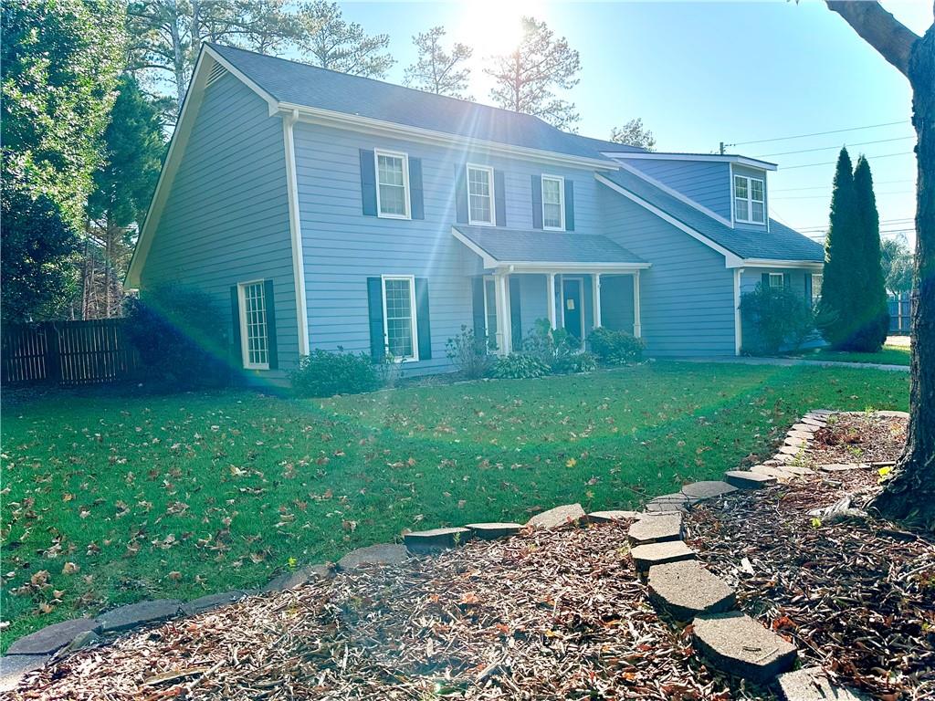 a view of a house with a yard