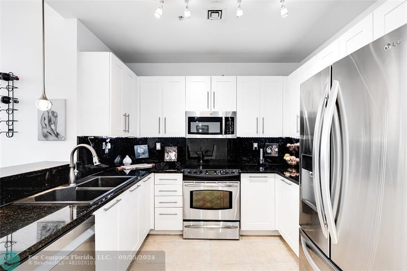 a kitchen with a sink a stove and refrigerator