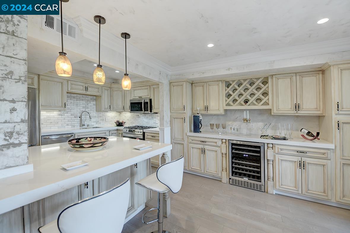 a kitchen with stainless steel appliances a stove a sink and cabinets