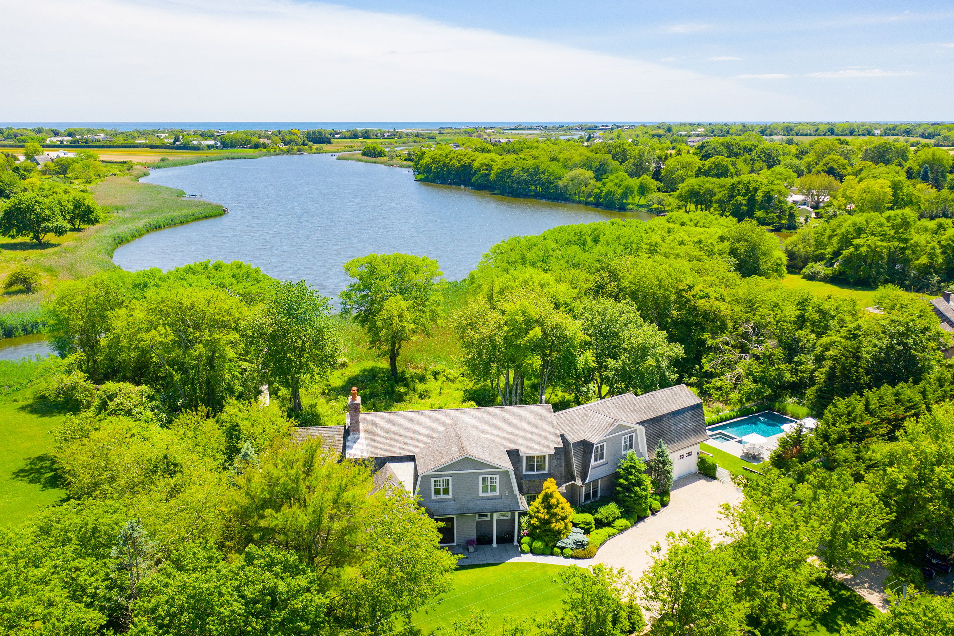 an aerial view of a houses with a lake view