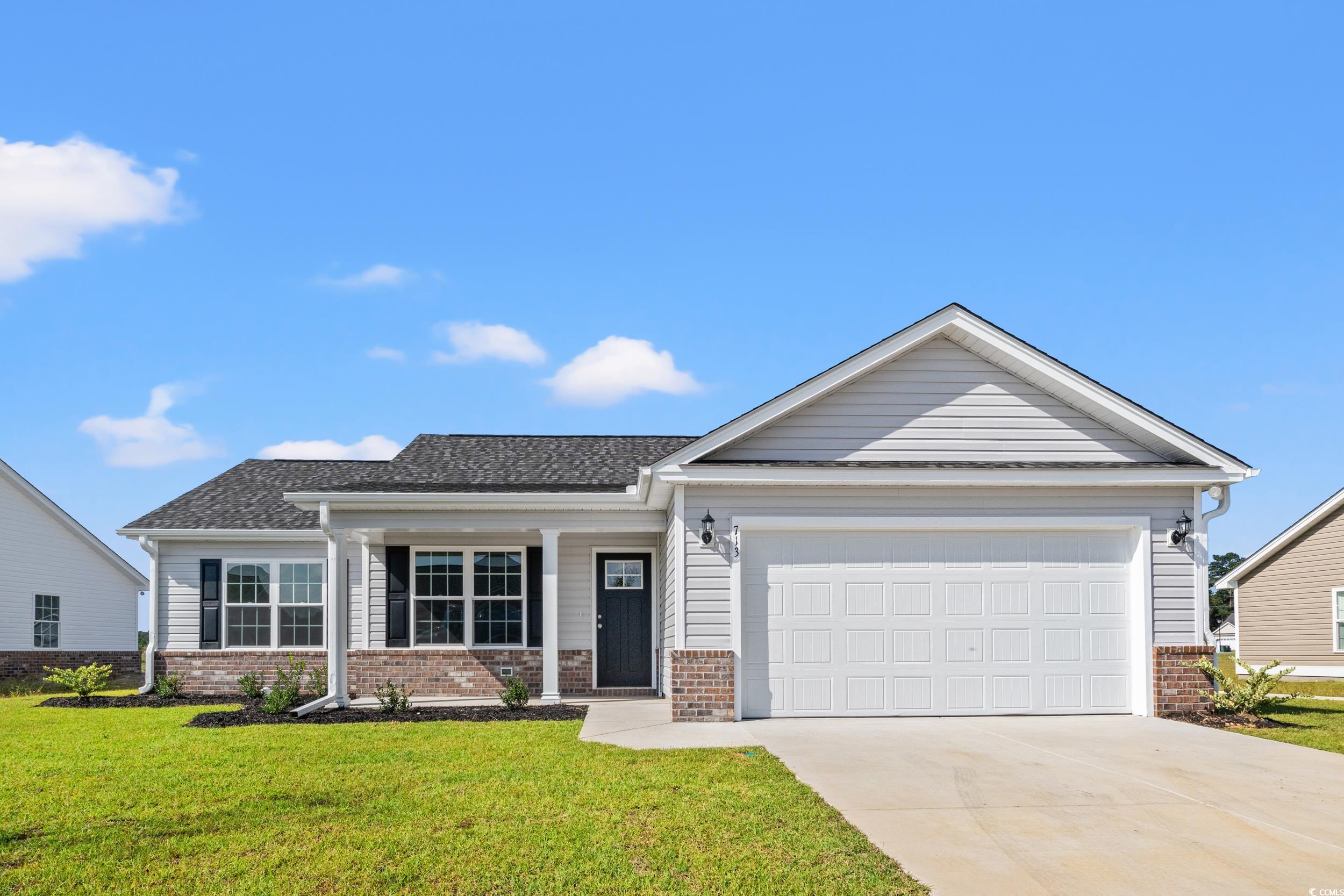 View of front of house with a garage and a front l