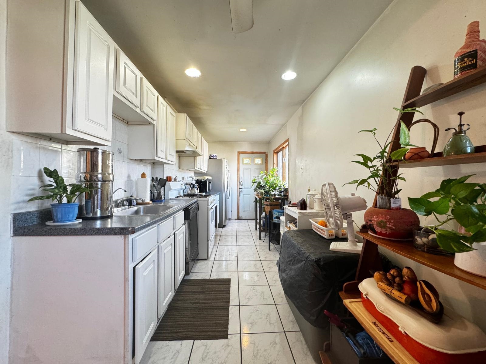 a kitchen with stainless steel appliances granite countertop a lot of counter space and a sink