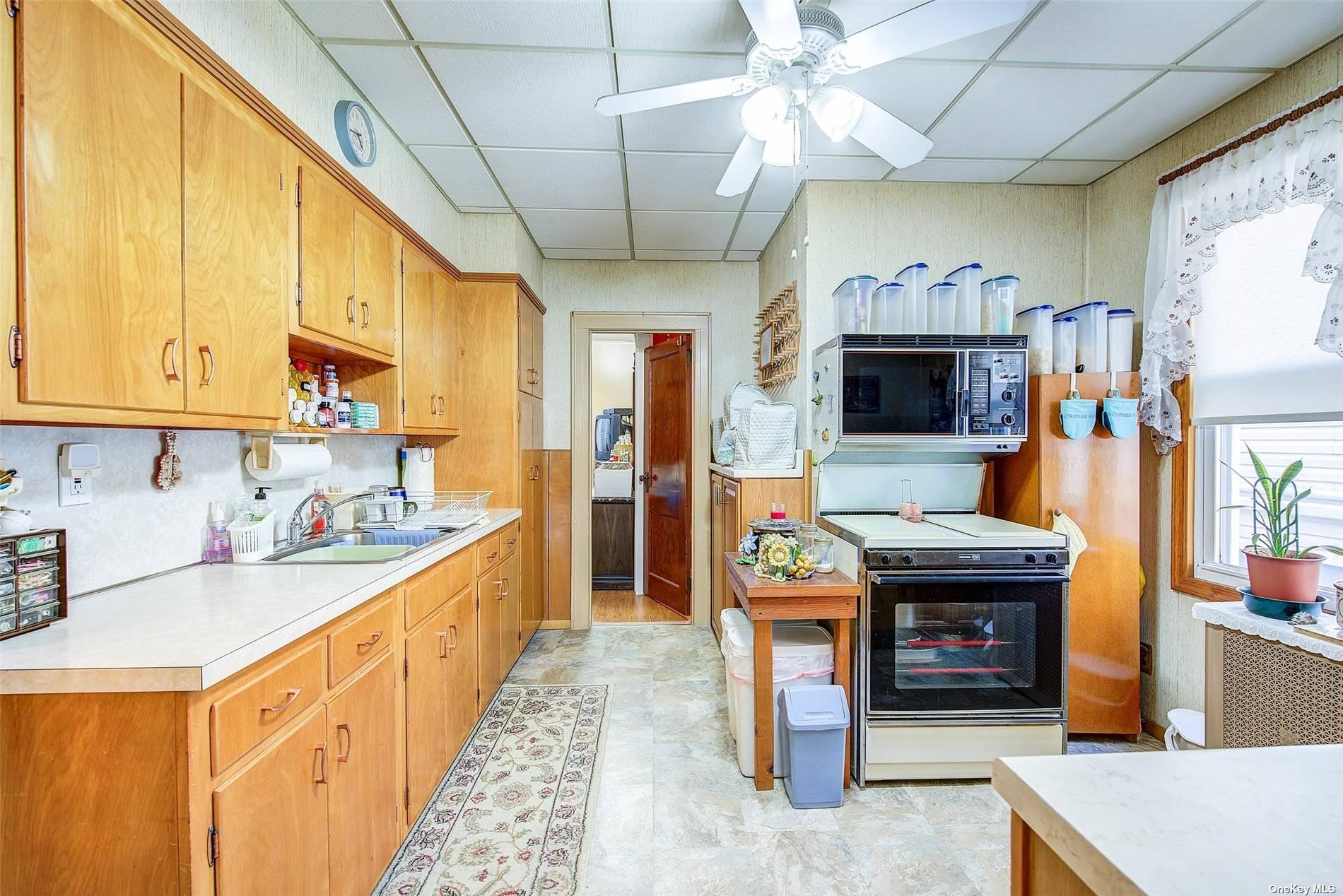 a kitchen with stainless steel appliances granite countertop a sink a stove and a wooden cabinets