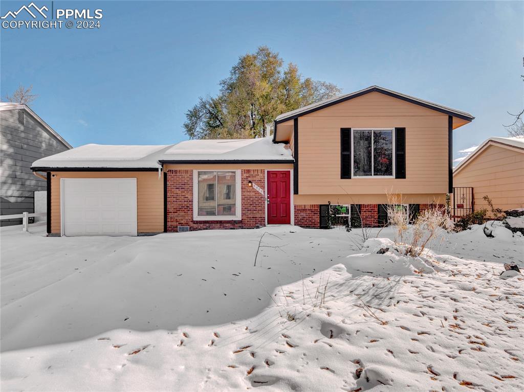 a front view of a house with a snow