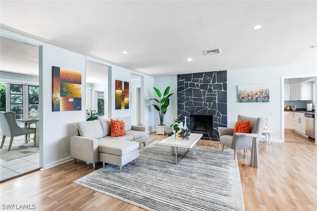 a living room with fireplace furniture and a wooden floor