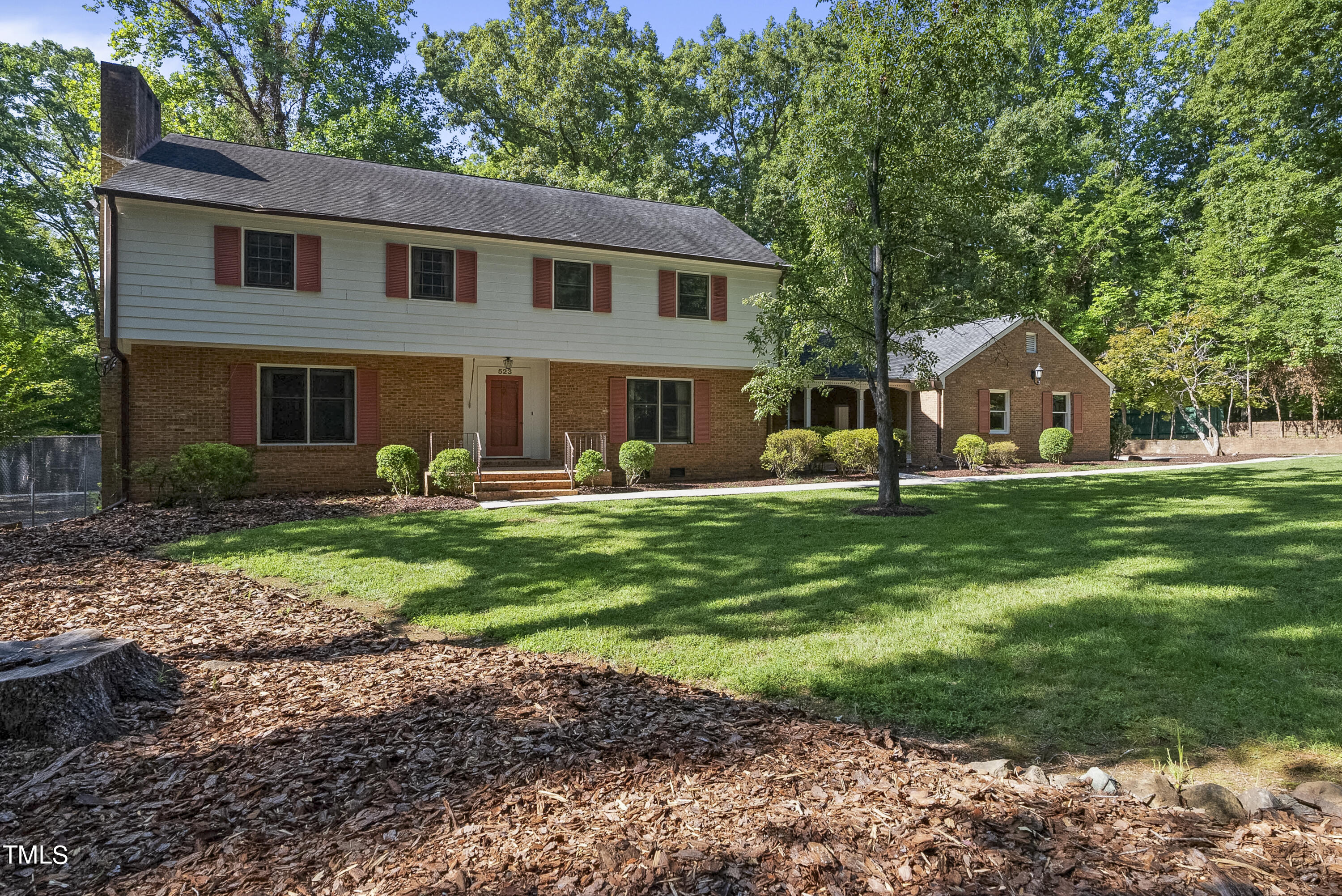 a front view of house with yard and green space