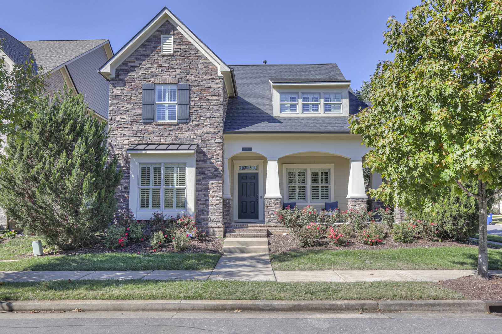 a front view of a house with garden