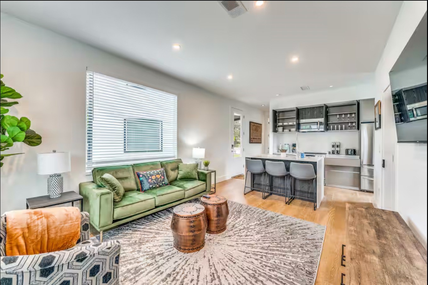 a living room with furniture and view of kitchen