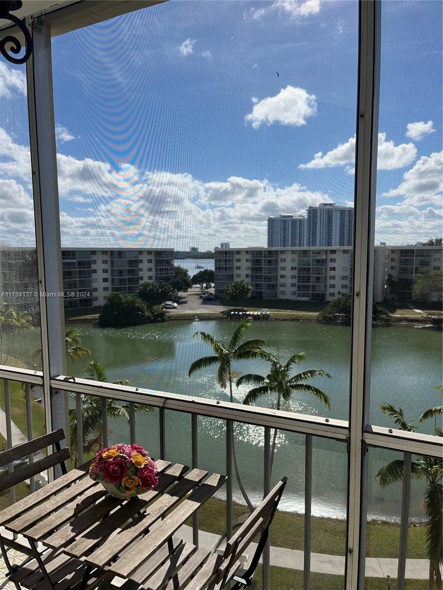 a view of a balcony with chair and table