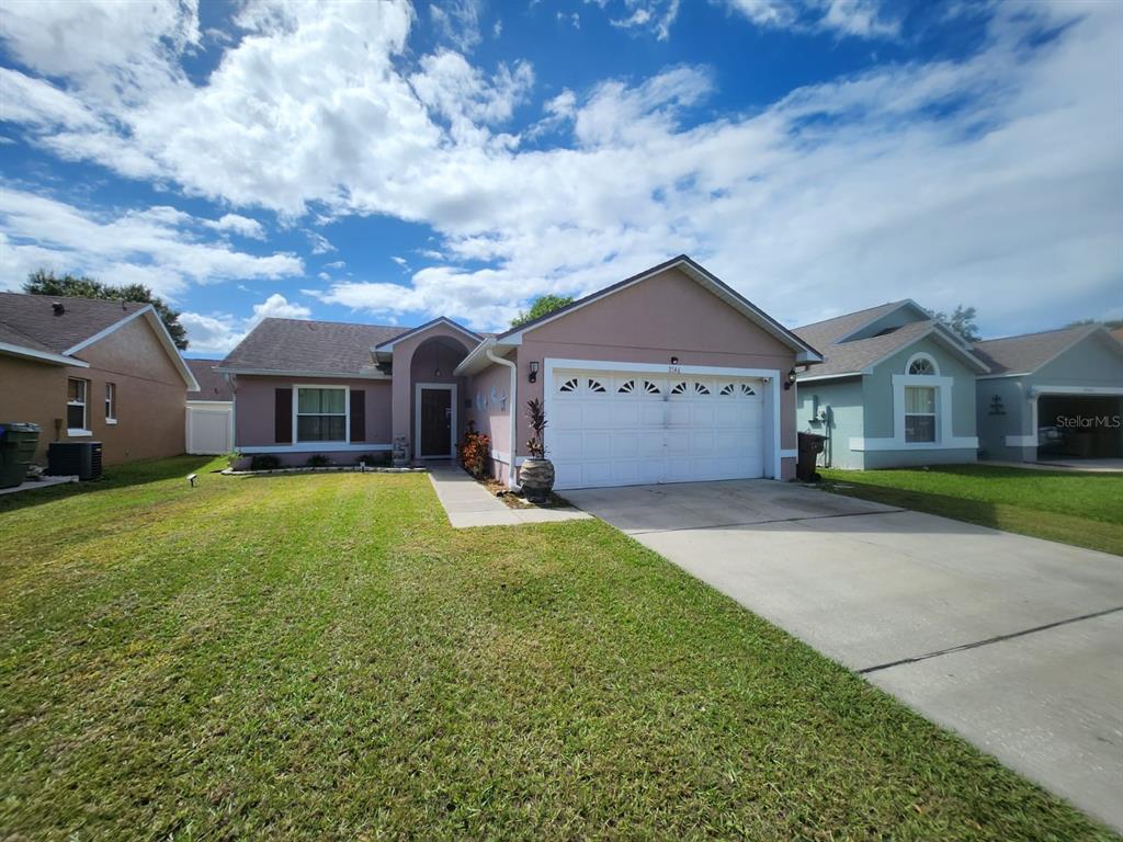 a front view of house with yard and green space