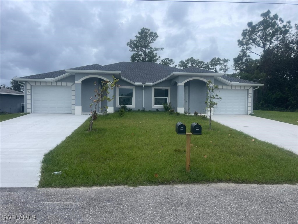 a front view of a house with a garden