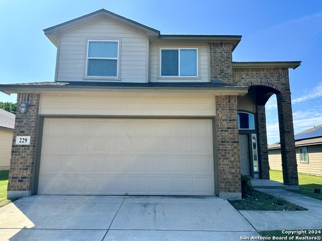 a front view of a house with garage