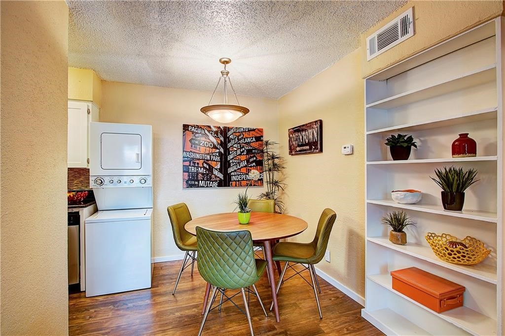 a view of a dining room with furniture and wooden floor