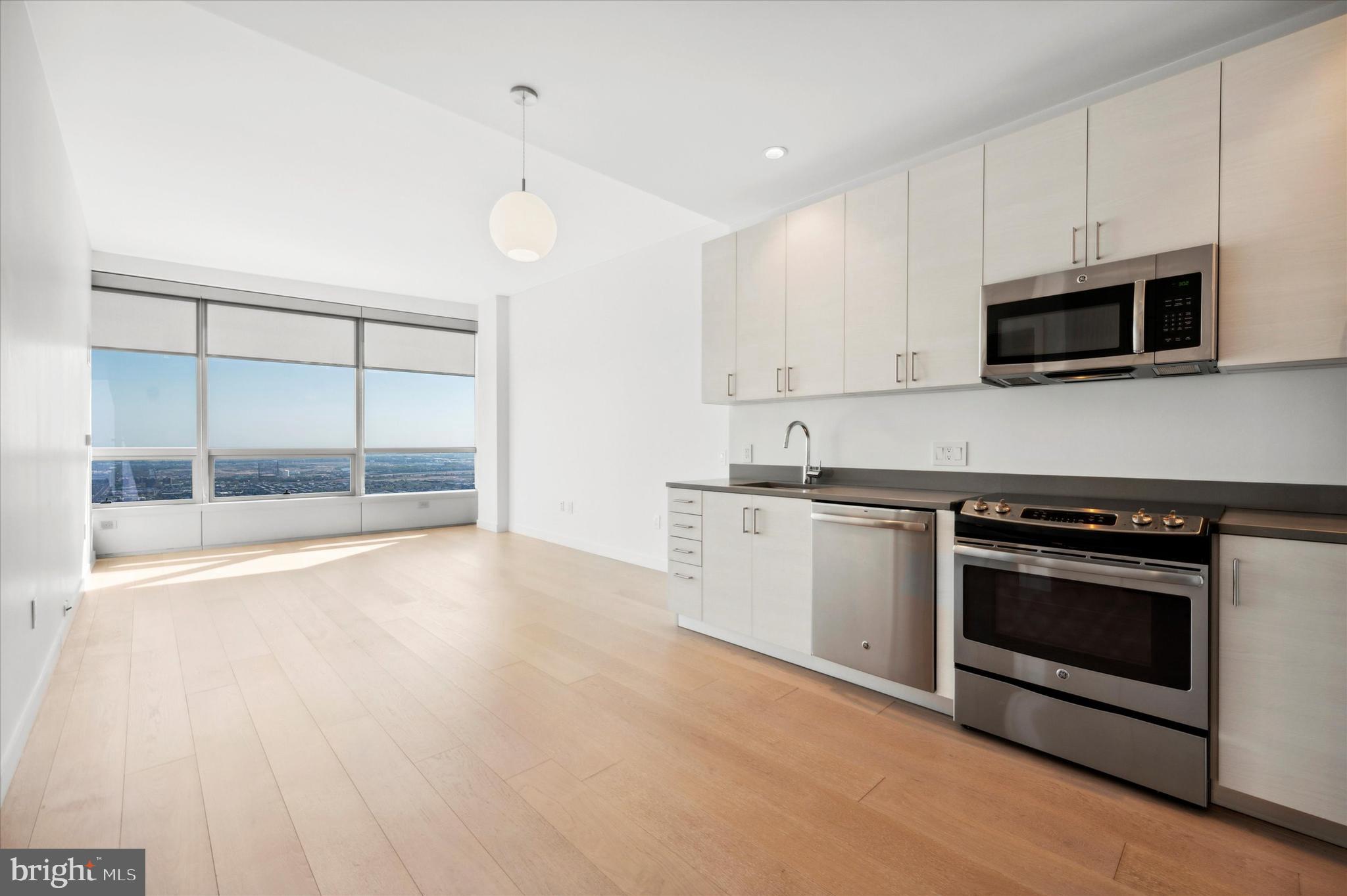 a kitchen with stainless steel appliances granite countertop a stove and a microwave