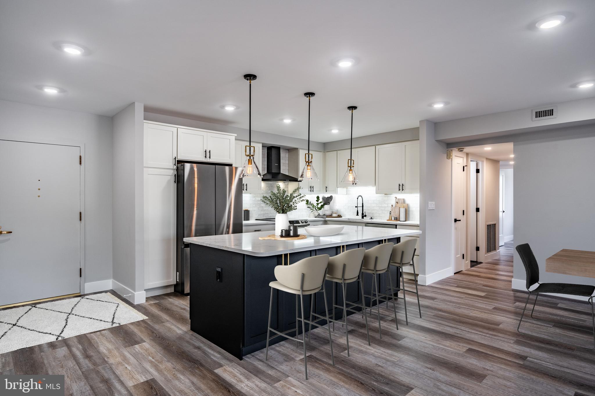 a kitchen with kitchen island a sink table and chairs