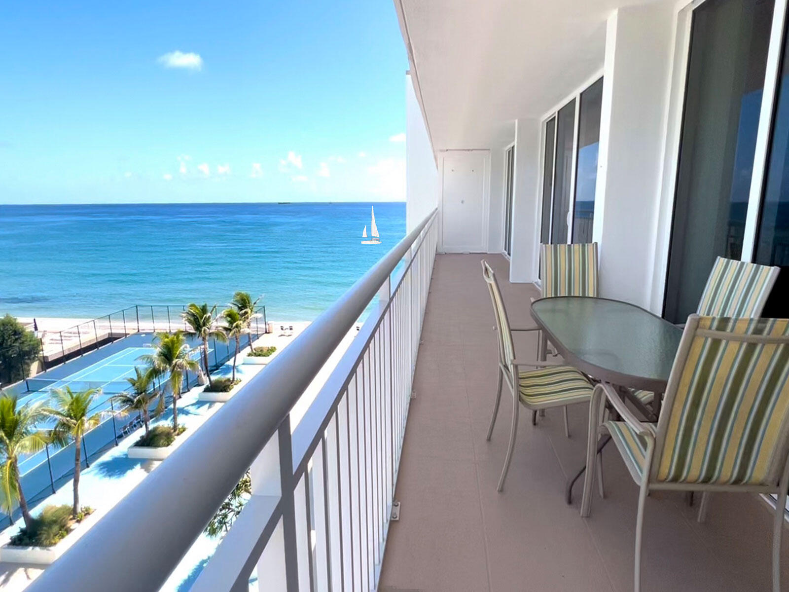 a view of a chairs and table in the balcony