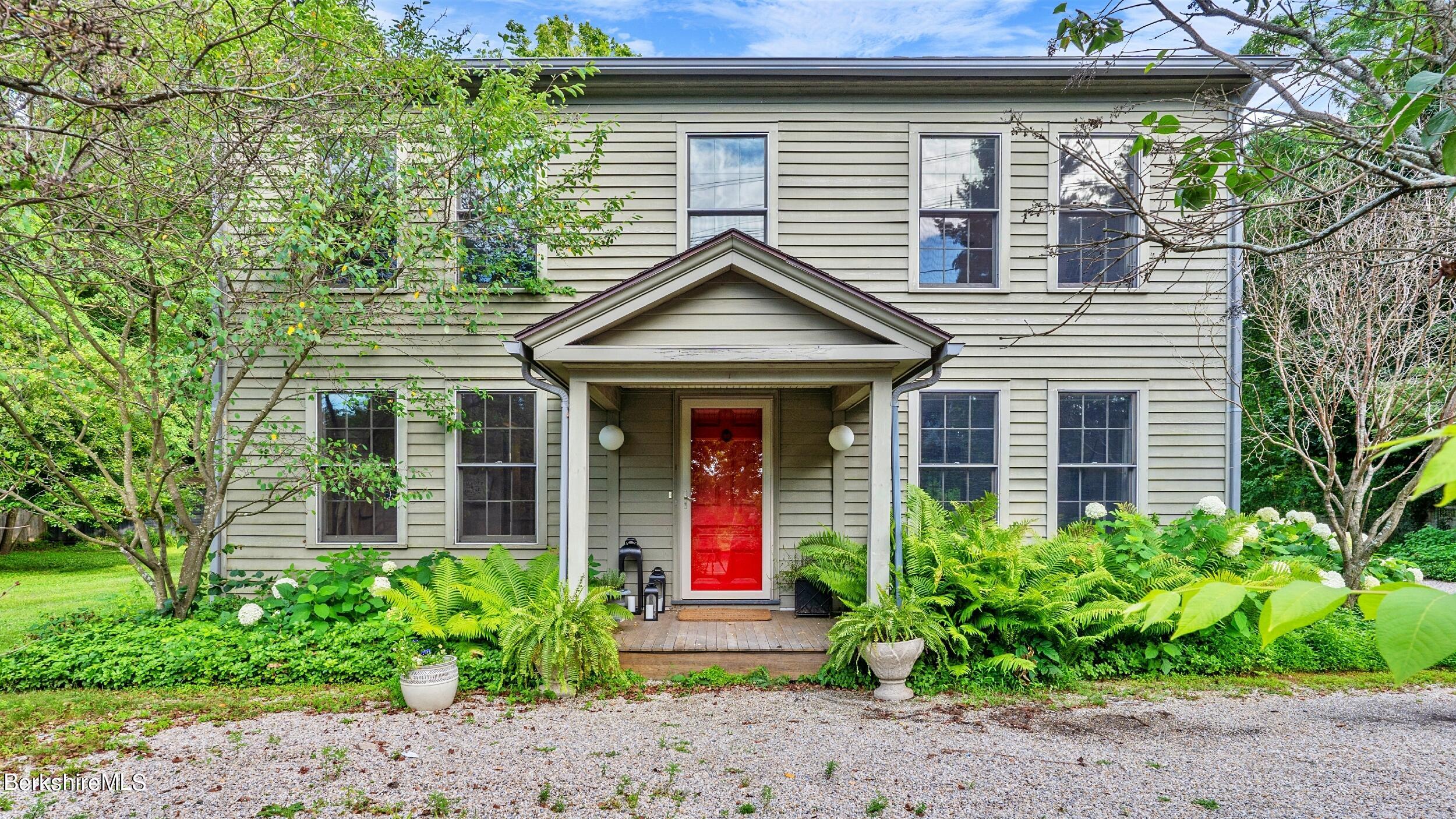 a front view of a house with garden