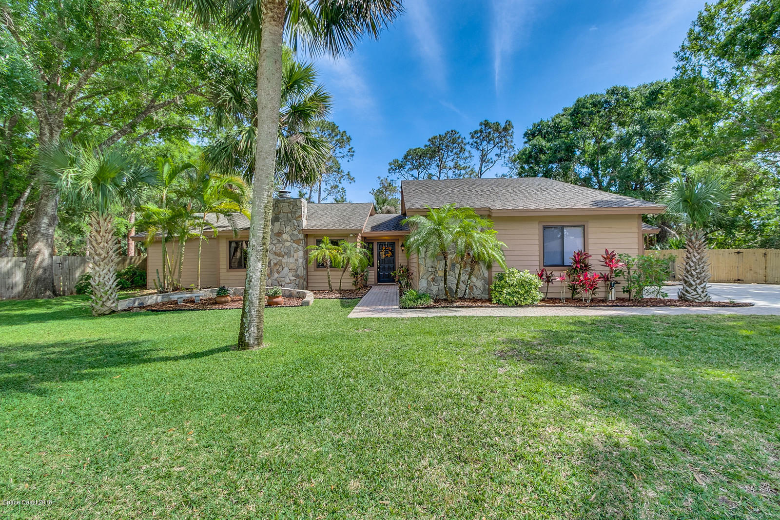 a view of a house with a backyard and a patio