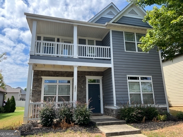 a front view of a house with a yard outdoor seating and garage