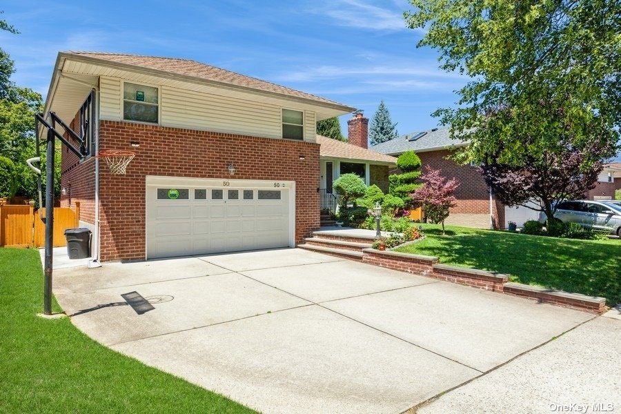 a front view of a house with a yard and garage