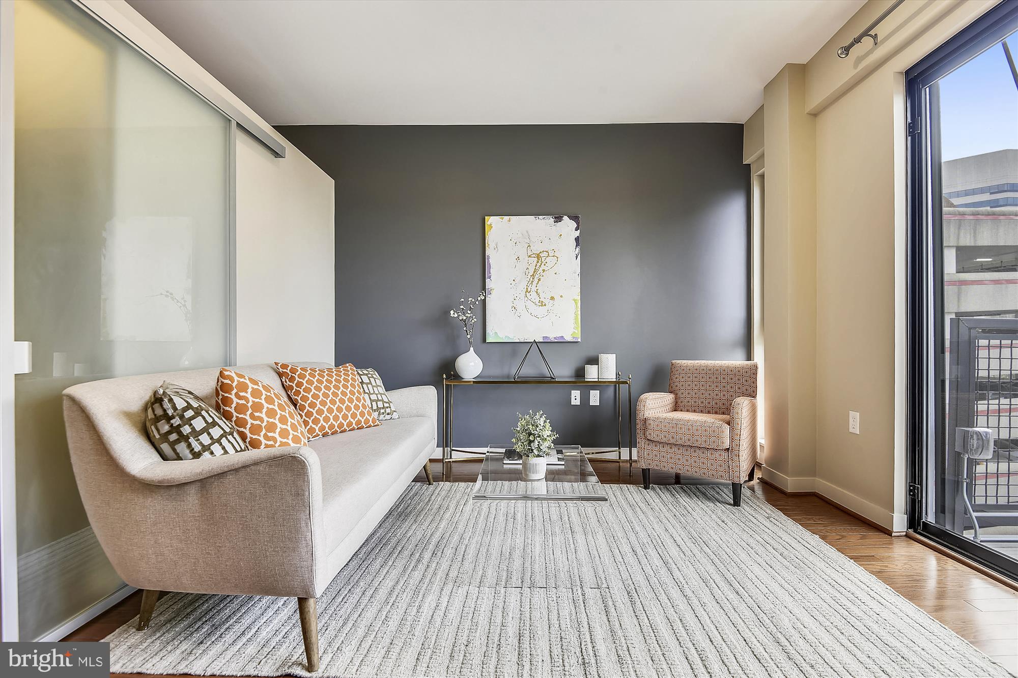 a living room with furniture and a wooden floor