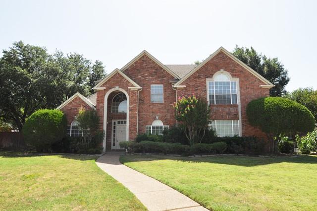 a front view of a house with yard