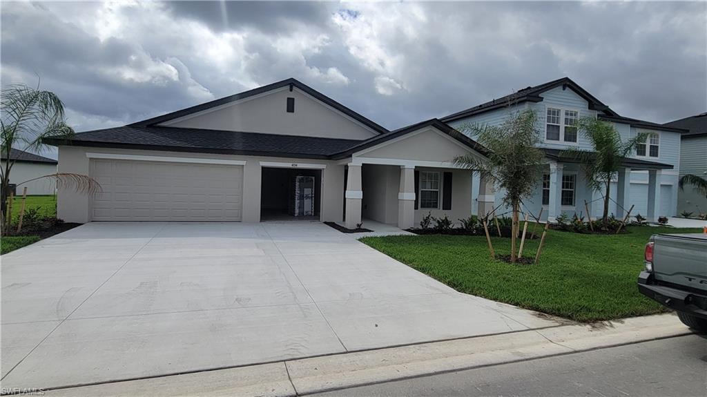 View of front facade with a front yard and a garage