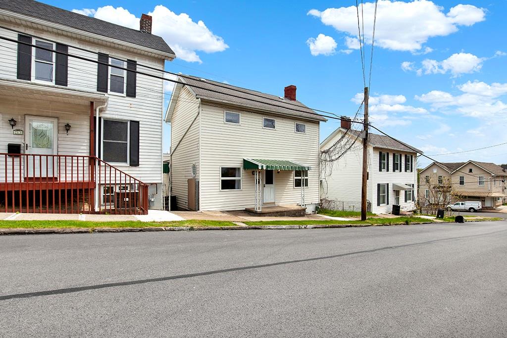 a view of a house with a small yard